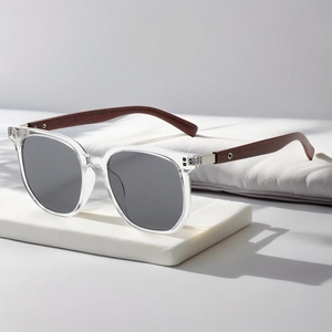 Detailed view of retro polygon sunglasses with wood grain temples on a display stand