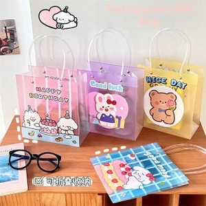 Detail of pink and purple cartoon PVC gift bags with cute animal prints and white handles