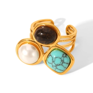Detailed macro view of gold adjustable ring set with pearl, turquoise, and tiger eye stone