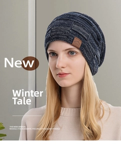 Detail of mixed-color knitted beanie showing square pattern texture and leather Sports label
