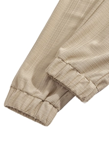 Macro shot of khaki drawstring cuff with textured high-density elastic fabric on pants