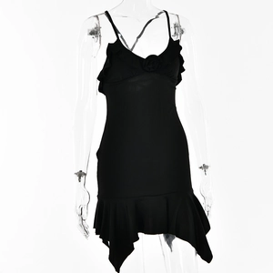 Detail of black V-neck slip dress featuring 3D floral accent and irregular ruffled hem