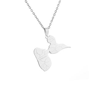 Macro detail of silver stainless steel Guadeloupe map pendant with engraved lettering
