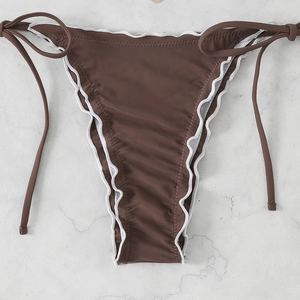 Detail of brown bikini bottoms with white scalloped edges and side tie strings