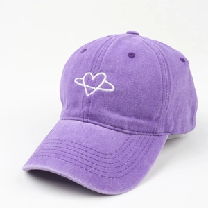 Detail of purple washed cotton baseball cap with white embroidered heart planet