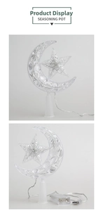 Detail of star and moon LED tree topper with dual USB/battery power and a white base
