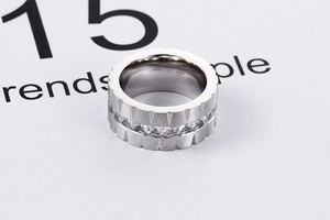 Detail of silver titanium steel ring featuring brushed texture and zircon inlay