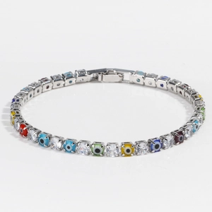 Close-up of silver tennis bracelet with colorful evil eye beads and clear cubic zirconia