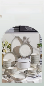 Detailed view of cream ceramic dinnerware set with elegant wavy matte texture