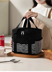 Detail of insulated lunch bag with white wave pattern and side mesh storage pockets