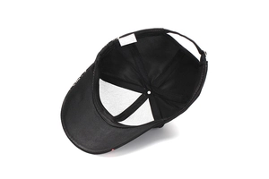Detail view of the internal 100% cotton label and stitching of the black dragon baseball cap
