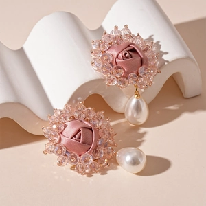 Detail of pink fabric rose earrings with crystal beads and waterdrop pearl pendants