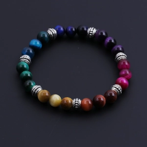 Macro shot of 8mm multicolor tiger eye beads with silver floral metal spacers