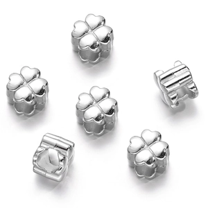 Macro shot of silver four-leaf clover CCB beads for DIY jewelry making and crafts