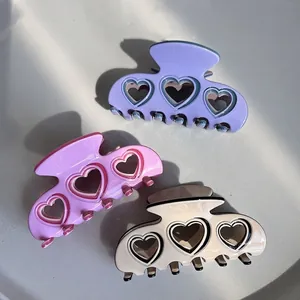 Three-piece acetate heart hair clips in purple, pink, and beige for daily styling