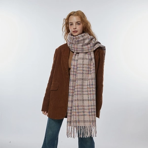 Soft pink plaid checkered scarf with fringe tassels worn with a brown corduroy jacket