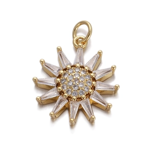 Detailed close-up of a gold sun-shaped pendant featuring sparkling cubic zirconia stones