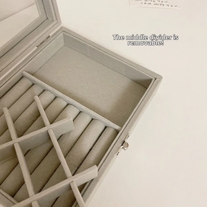 Detail view of large grey velvet jewelry box with removable inner divider and ring slots