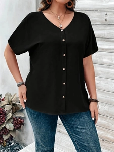 Close-up of black V-neck short sleeve shirt with single-breasted buttons and light fabric