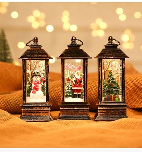 Close-up of vintage bronze Christmas phone booth lanterns with Santa and snowman figurines