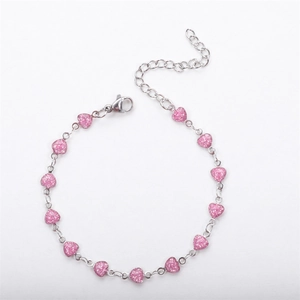 Detailed close-up of 18K gold-plated heart bracelet with pink glitter charms and clasp