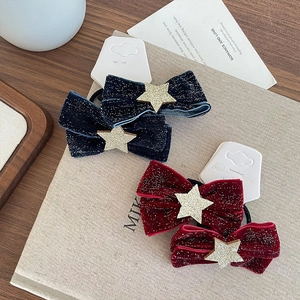 Velvet bow hair ties with glitter stars in dark blue and red on decorative background