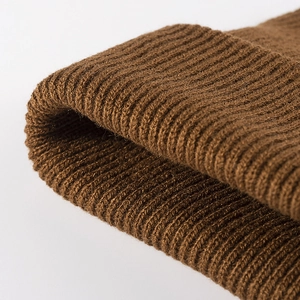 Deep brown thick ribbed knit beanie hat for winter, close-up texture and cuff detail