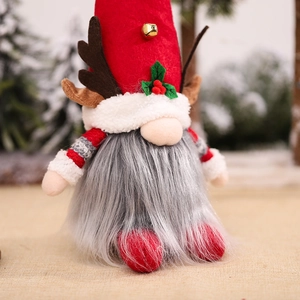 Christmas gnome plush with glowing reindeer antlers and red hat on burlap background