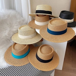 Flat top straw sun hats collection with decorative ribbons in various elegant colors