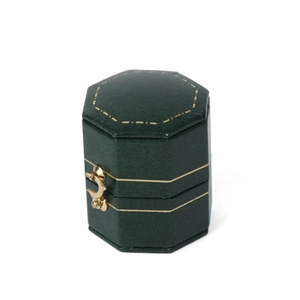 Green octagonal leather ring box with golden metal clasp on a clean white background