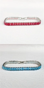 Detail of tennis bracelets with rectangular red and blue zircon stones in silver settings