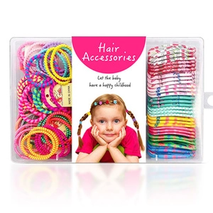 Detail of colorful elastic hair ties and snap hair clips in a clear gift box