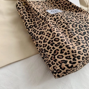 Detail of leopard print canvas tote bag showing side stitching and premium fabric texture