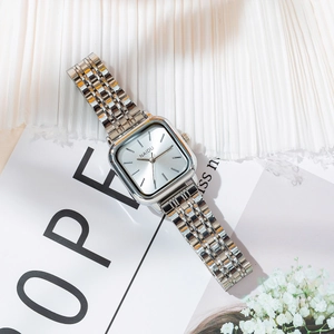 Detailed view of silver square dial watch with metal chain strap and NAIDU logo