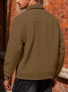 Detail of the corduroy shirt jacket back view featuring shoulder yoke and brown texture