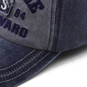 Close-up of vintage washed cotton baseball cap with detailed embroidery and contrast stitching
