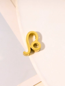 Close-up of golden Leo zodiac sign pendant in polished stainless steel finish