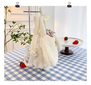 Close-up of white rabbit plush bag featuring a pink checkered bow and detachable strap