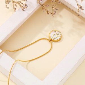Gold stainless steel Leo zodiac necklace featuring white shell pendant on snake chain