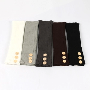 Detail of ribbed knit leg warmers in various colors featuring vintage wooden buttons