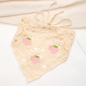 Detailed macro view of handmade crochet knit triangle headscarf with pink peach patterns