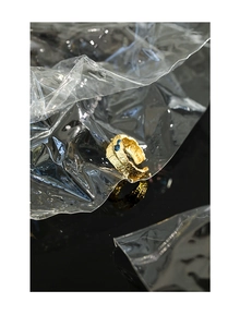 Macro shot of S925 sterling silver stamp on golden lava textured ring with blue stones