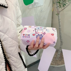 Detail shot of cute bear cartoon canvas pouch being held by hand for stationery storage