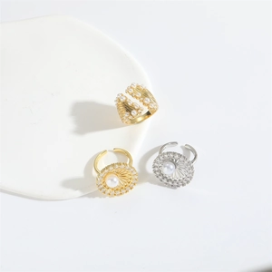 Detailed view of floral rings featuring gold shell texture and pearl sunflower designs