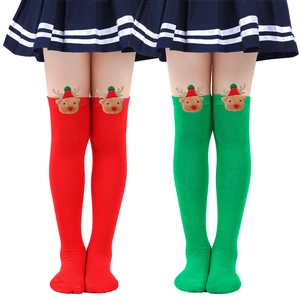 Detail of kids Christmas socks featuring 3D plush reindeer on red and green knit fabric