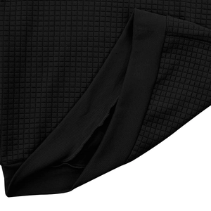 Close-up of black waffle knit texture and ribbed cuff detail on men's hoodie fabric