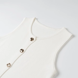 Close-up of white ribbed knit vest with decorative golden metal buttons on the front