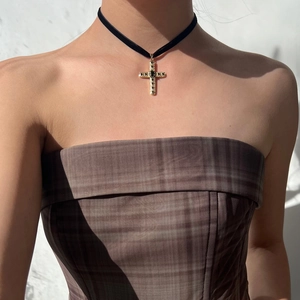 Gothic cross choker necklace with black gemstone pendant on model neck