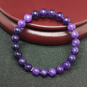 Macro shot of purple natural gemstone beads with smooth texture and polished finish