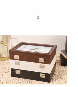 Detail view of folding wooden display boxes in brown, white, and black with glass panels